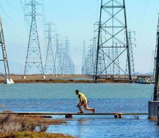 SWCA employee in front of a tower lighting structure installation in northern California.