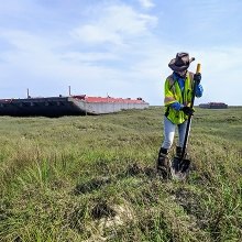 Survey with Beached Barges in Background