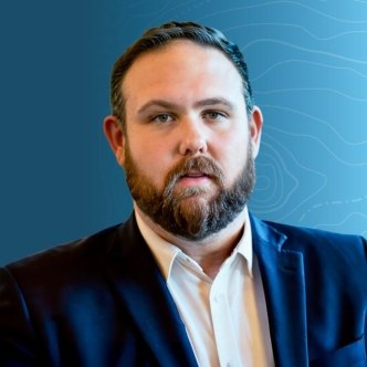 Headshot of Ross Pilotte on a blue topographic background.