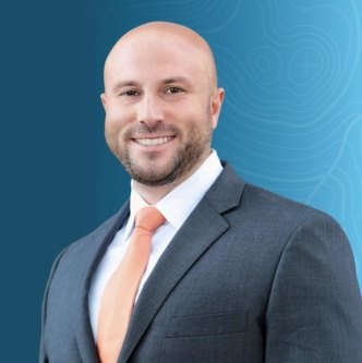 Headshot of Jon Schultis on a blue topographic background.