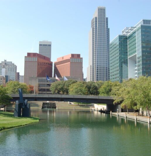 Several tall buildings and a bridge spanning a river.