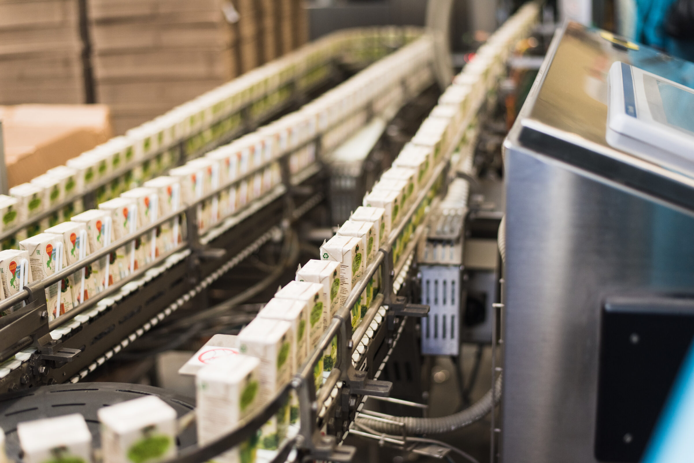 cardboard packaging of juices on a conveyor belt. 