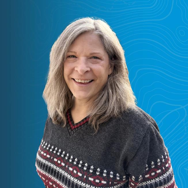 headshot of Janet Guinn, Principal Planning Team Lead, on a blue background