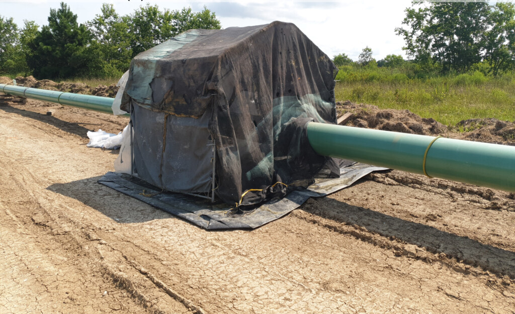 A CAD compressor foundation in between two pipes.