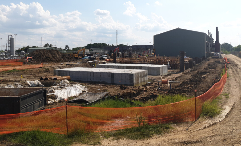 View of the Cavern 4 drill pad and construction site with equipment and orange fencing all around.