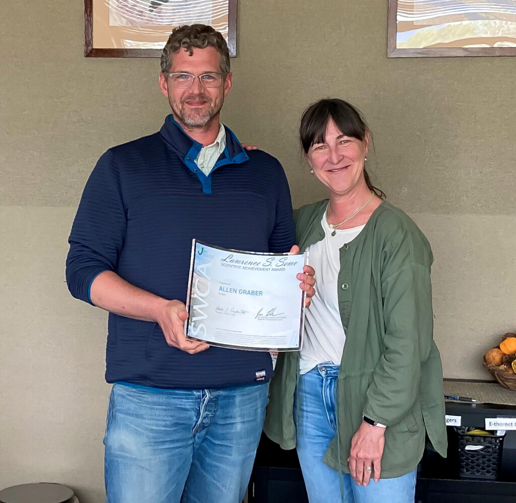 Allen Graber receiving the Larry Semo Award for Q2 2025 from Jill Grams in Flagstaff.