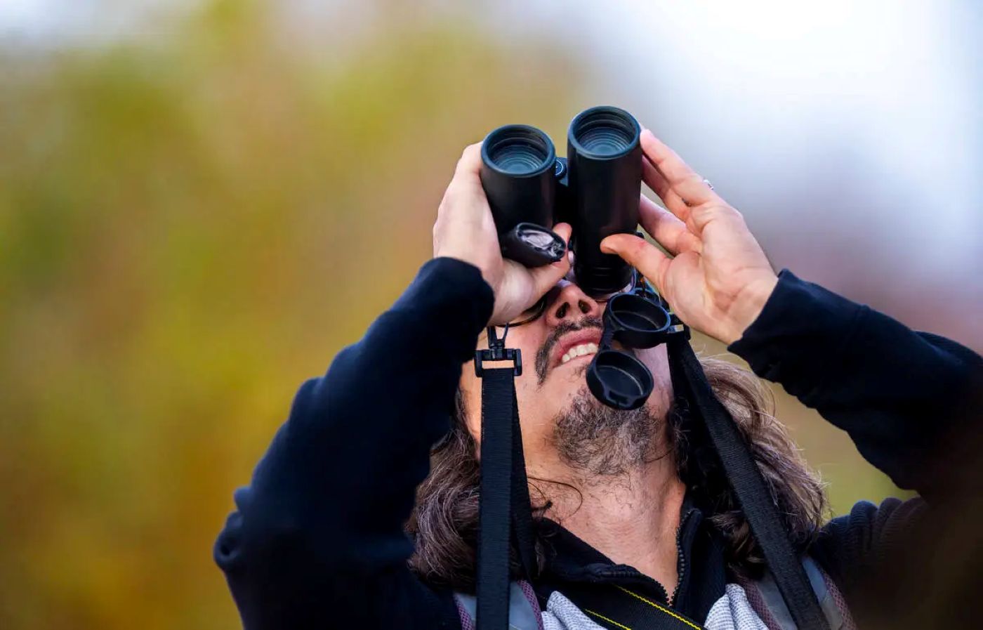 Justin Streit using binoculars and pointing up at the sky. Source: Las Vegas Review-Journal