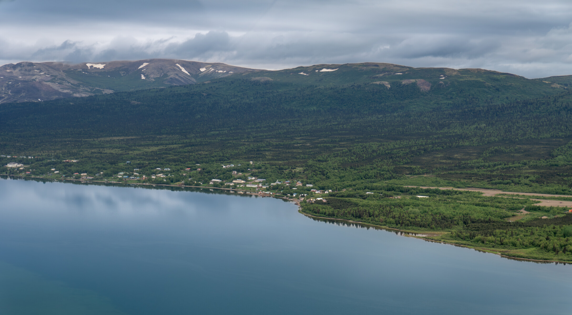 Mount Sukapak, Alaska with a stream with snow in front of it.