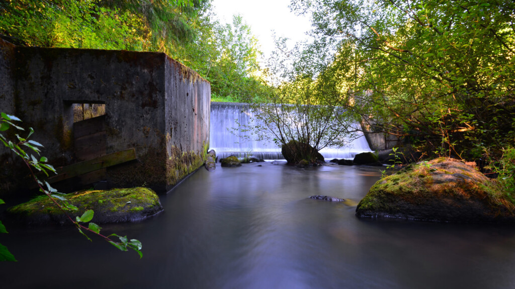 View of existing concrete dam and fish ladder structure.