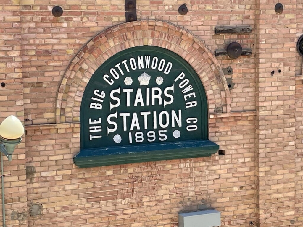 A sign on a brick building with the words "The Big Cottonwood Power Co. Stairs Station 1895"