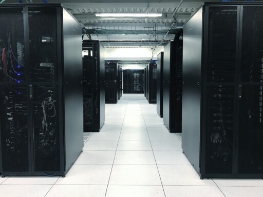 row of server racks or network device racks in data center
